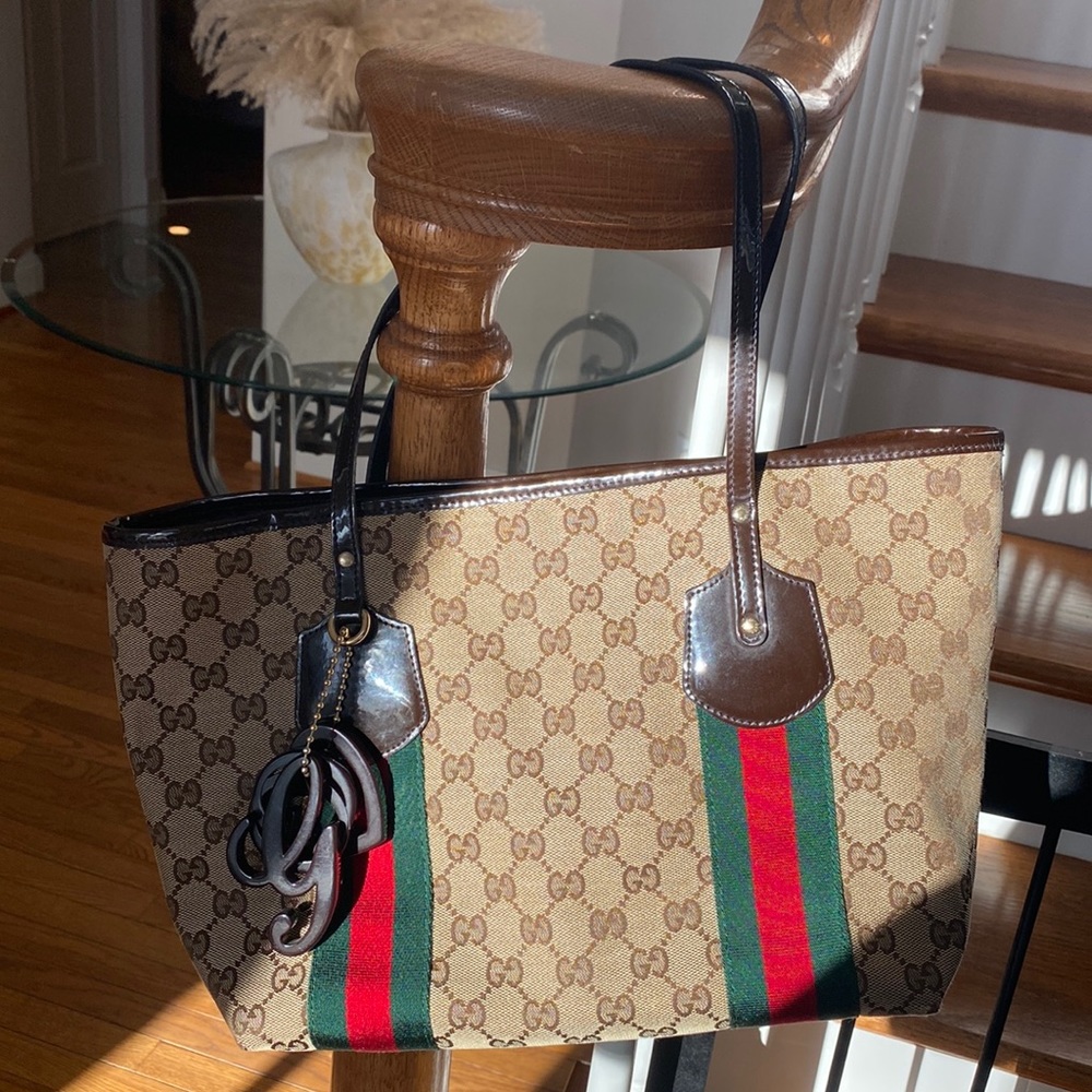 Authentic Gucci brown monogram canvas tote!With three charms.Near perfect!